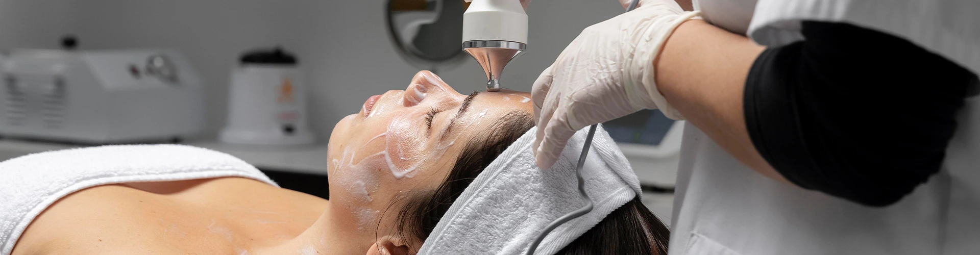 Tratamento facial avançado em clínica com aparelho estético profissional, esteticista a aplicar tecnologia para rejuvenescimento